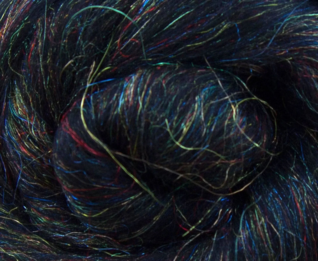 Close view of black merino fiber showing rainbow sparkle.
