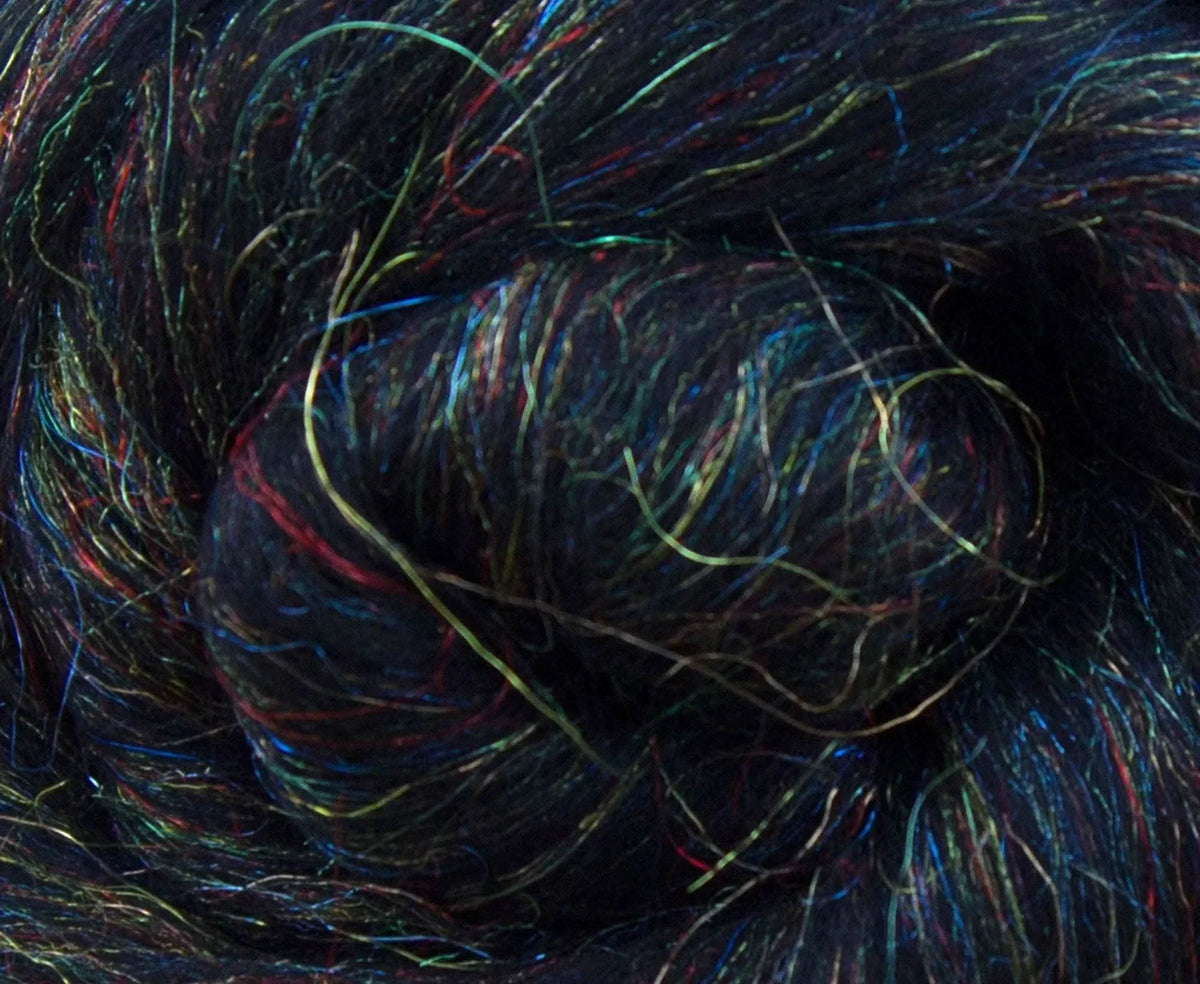 Close view of black merino fiber showing rainbow sparkle.
