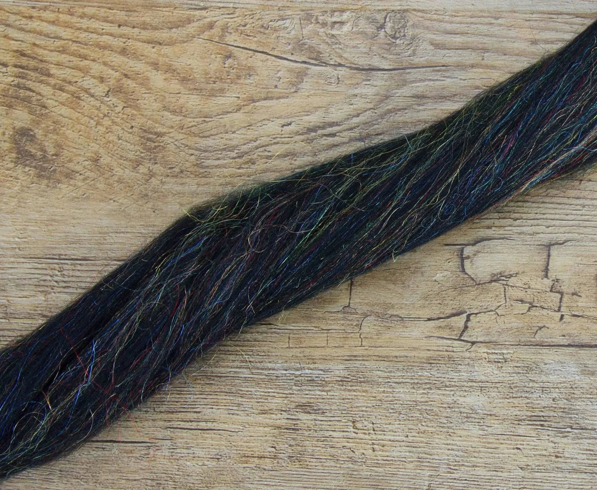 Black merino combed top with rainbow sparkles laid out ready to spin
